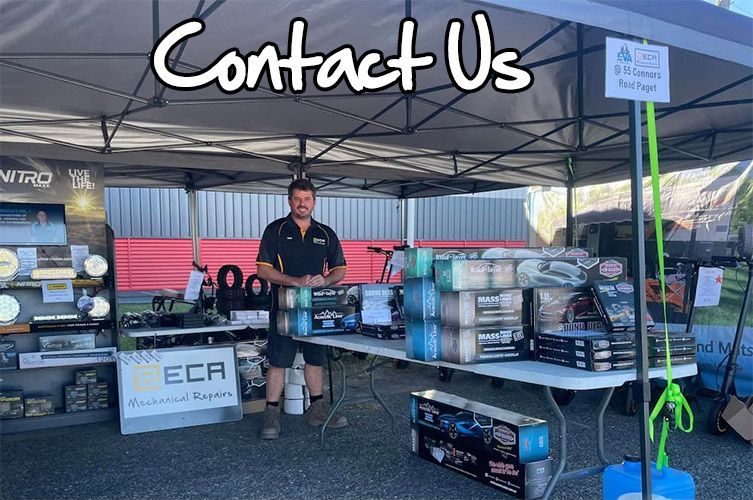 Man at outdoor vendor stall. Products displayed on tables under a canopy — E.C.A Mechanical Repairs in Paget, QLD