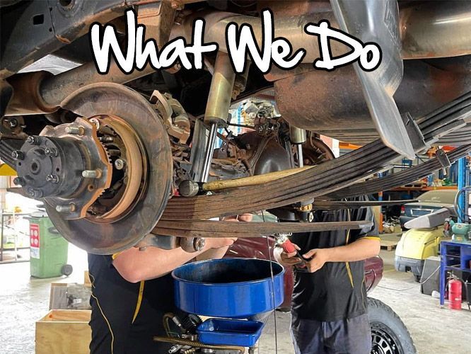 Two Mechanics Working on a Car's Undercarriage — E.C.A Mechanical Repairs in Paget, QLD