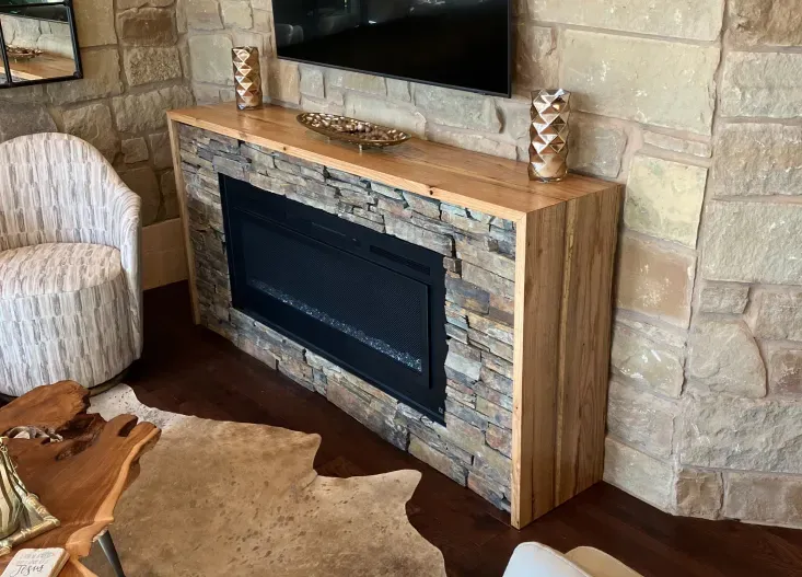 A living room with a fireplace and a flat screen tv.