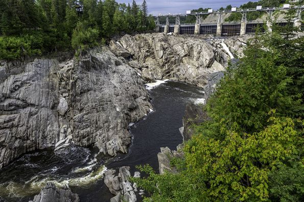 An aerial view of a river surrounded by rocks and trees.
