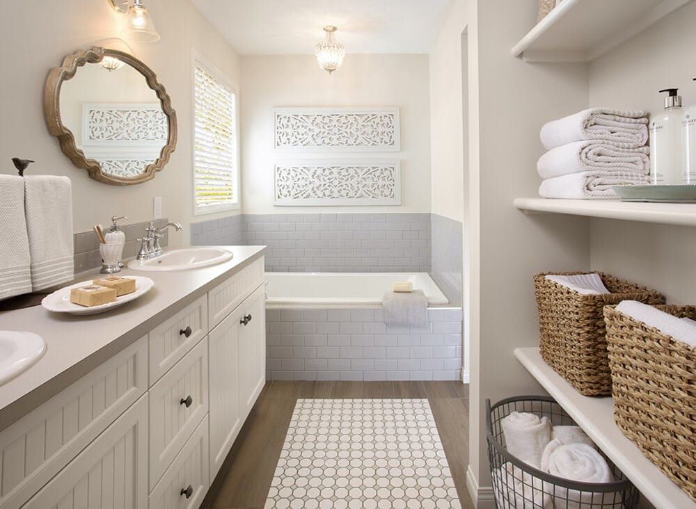 Bathroom with vanity, bathtub, shelving, and neutral color scheme.