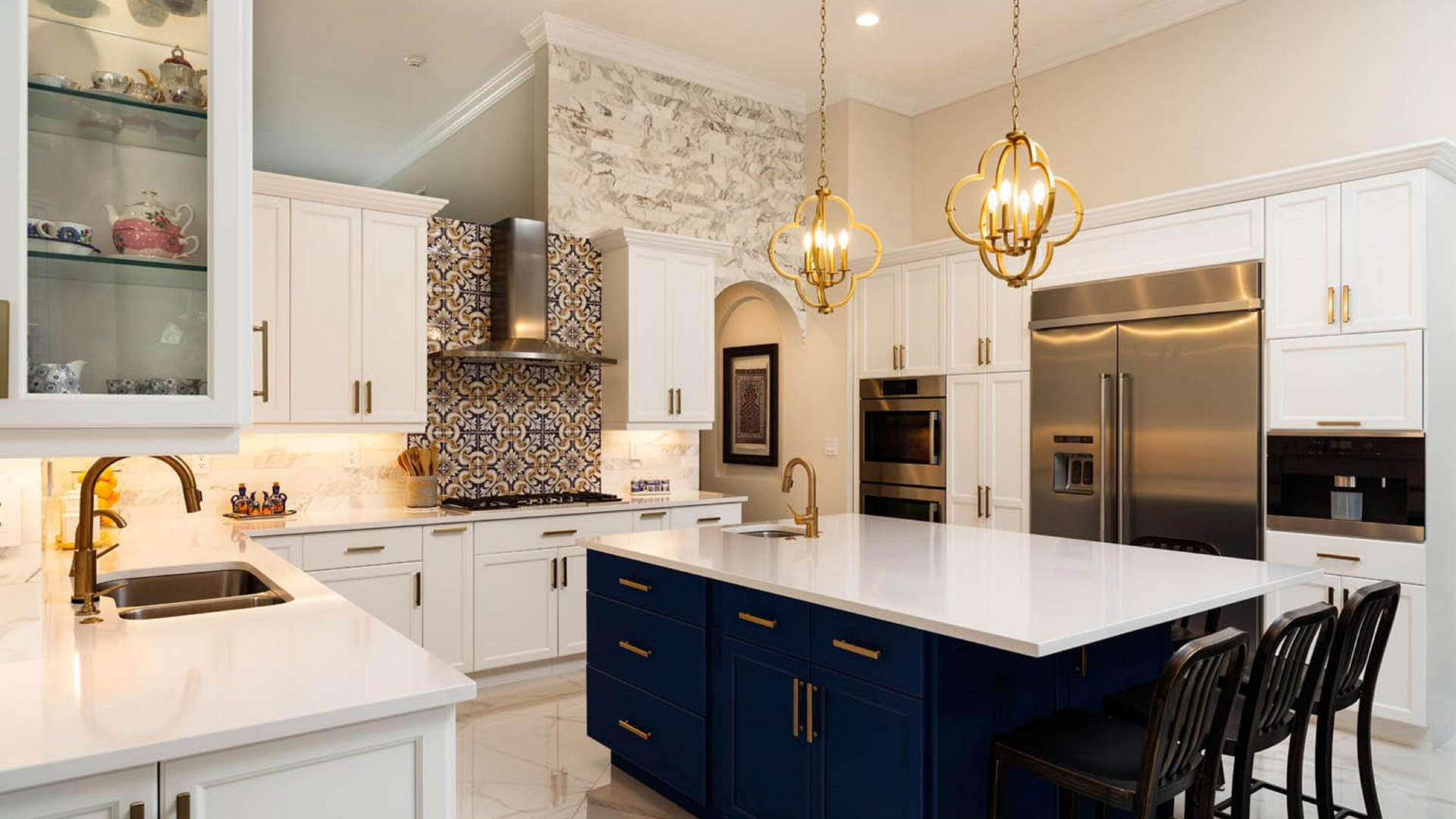 Modern white kitchen with blue island and gold accents.