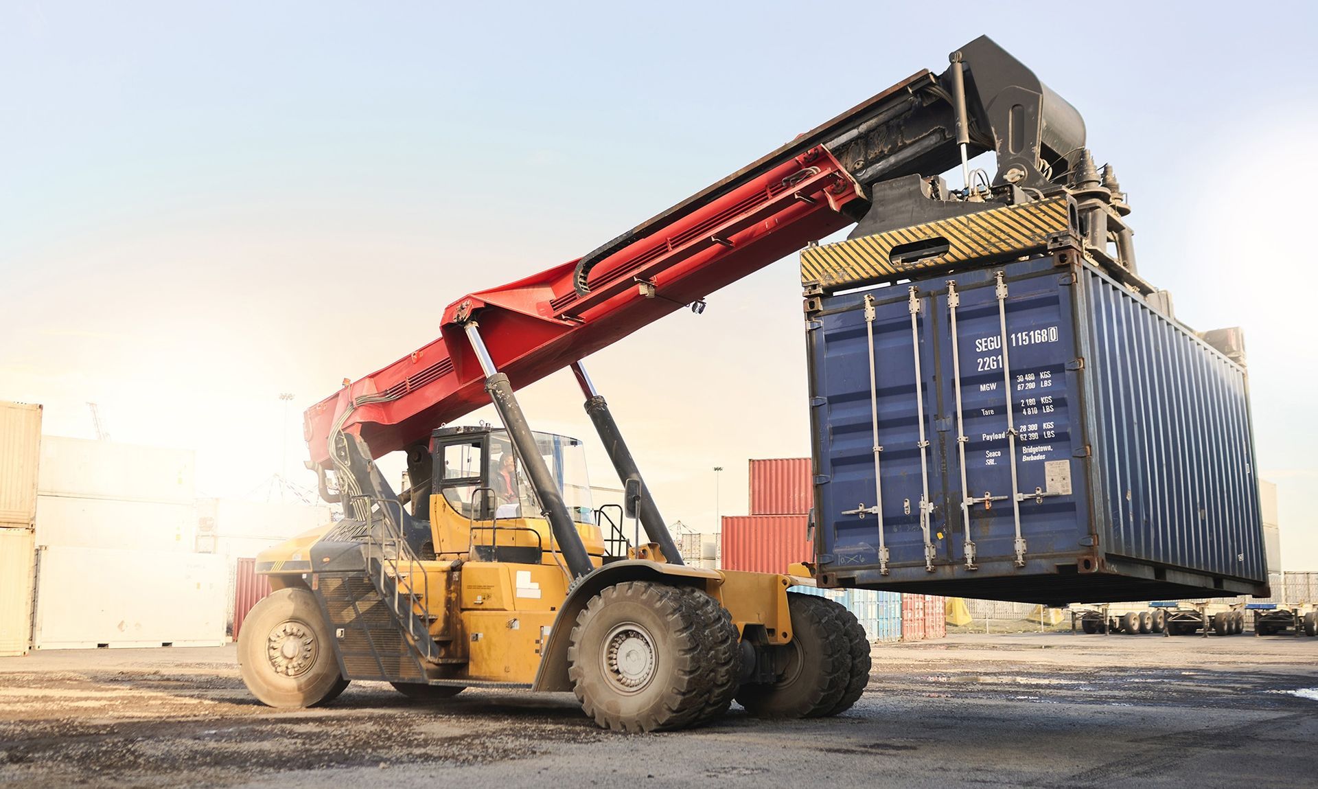 a forklift lifting a container onto a truck