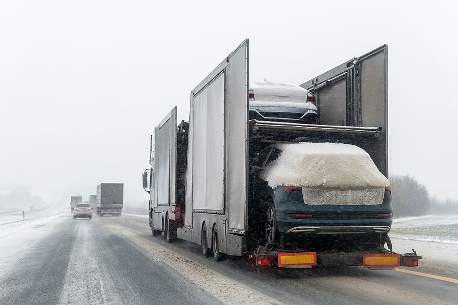 a semi truck is driving down a snowy road
