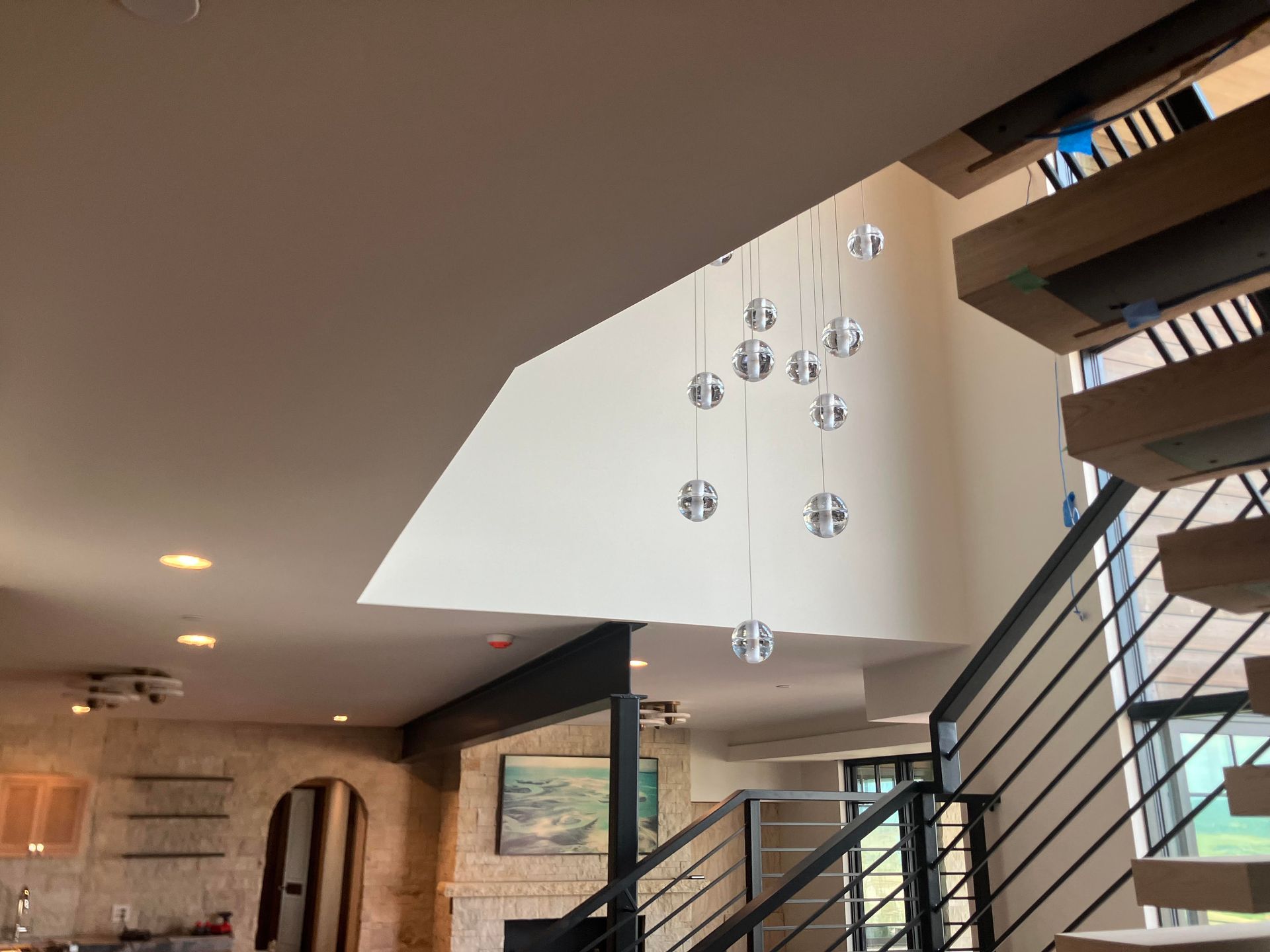 Modern home interior with staircase and pendant light fixture.