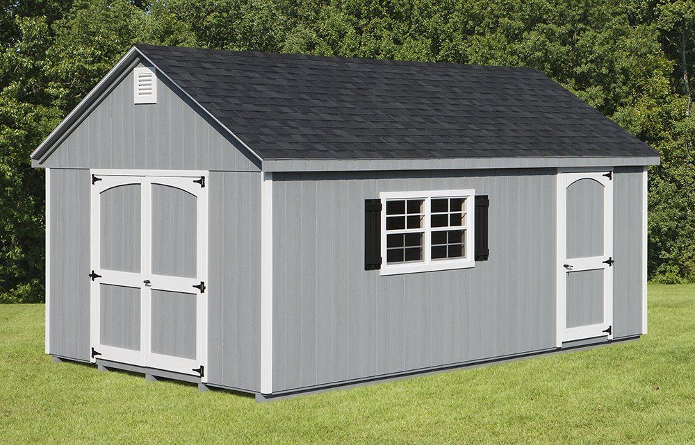Gray shed with white trim, black roof, and small window on green grass.