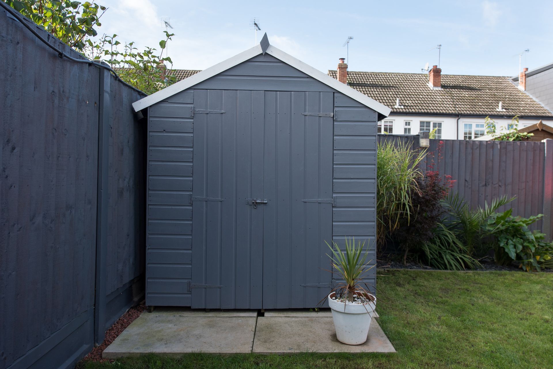 Grey backyard shed illustrating outdoor storage shed installation services for efficient storage.