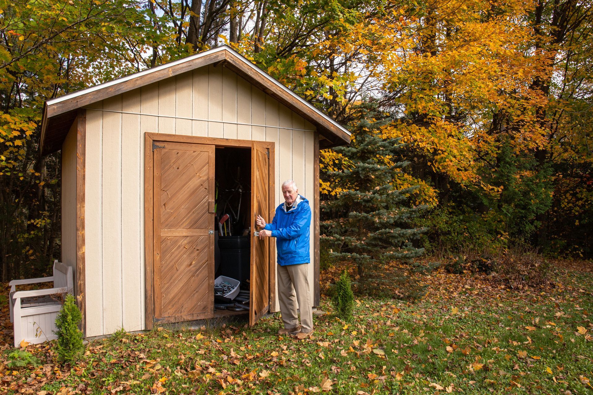 A man outside his storage shed.