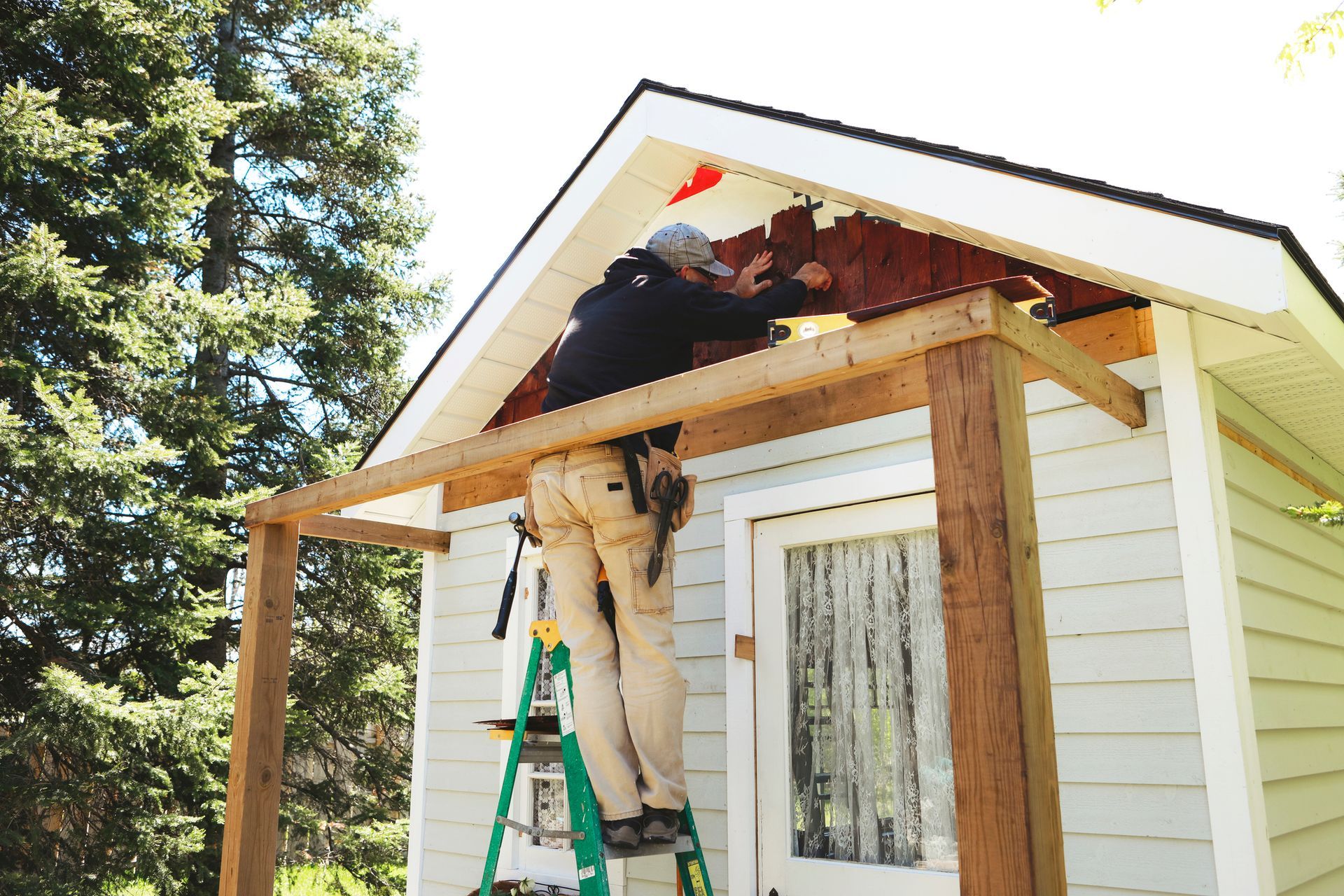 A carpenter is building a storage shed.