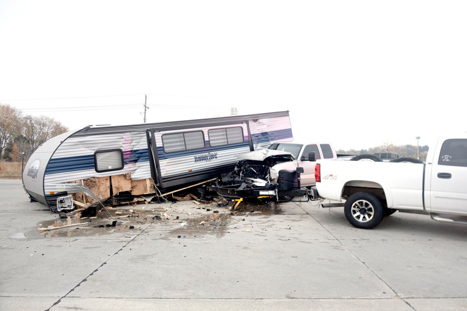 A rv has crashed into a truck in a parking lot.