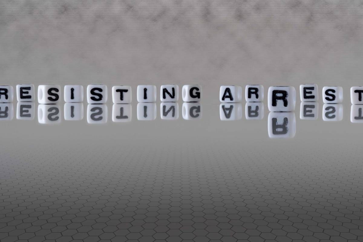 The word “resisting arrest” on white letter cubes on a gray background at JPS Law near Lexington, Kentucky (KY)