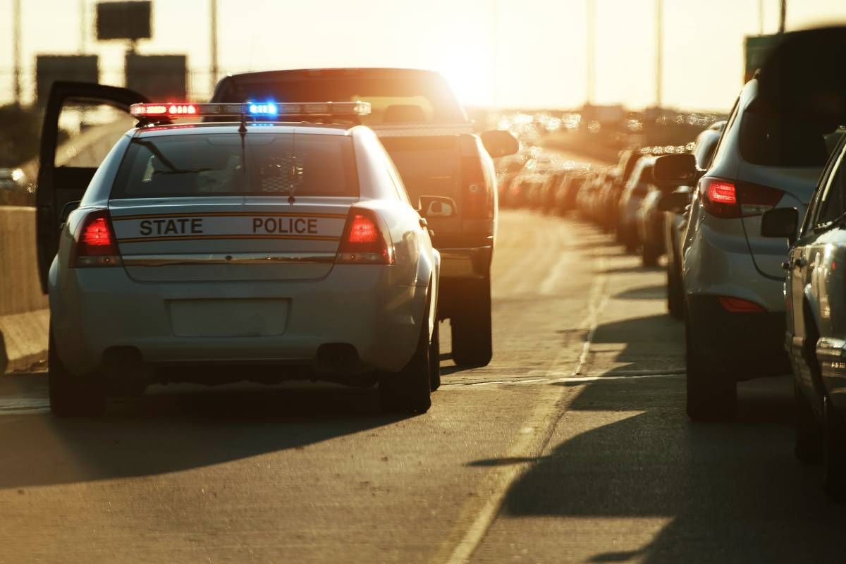 A police officer stopping a car by the highway near Lexington, Kentucky (KY)