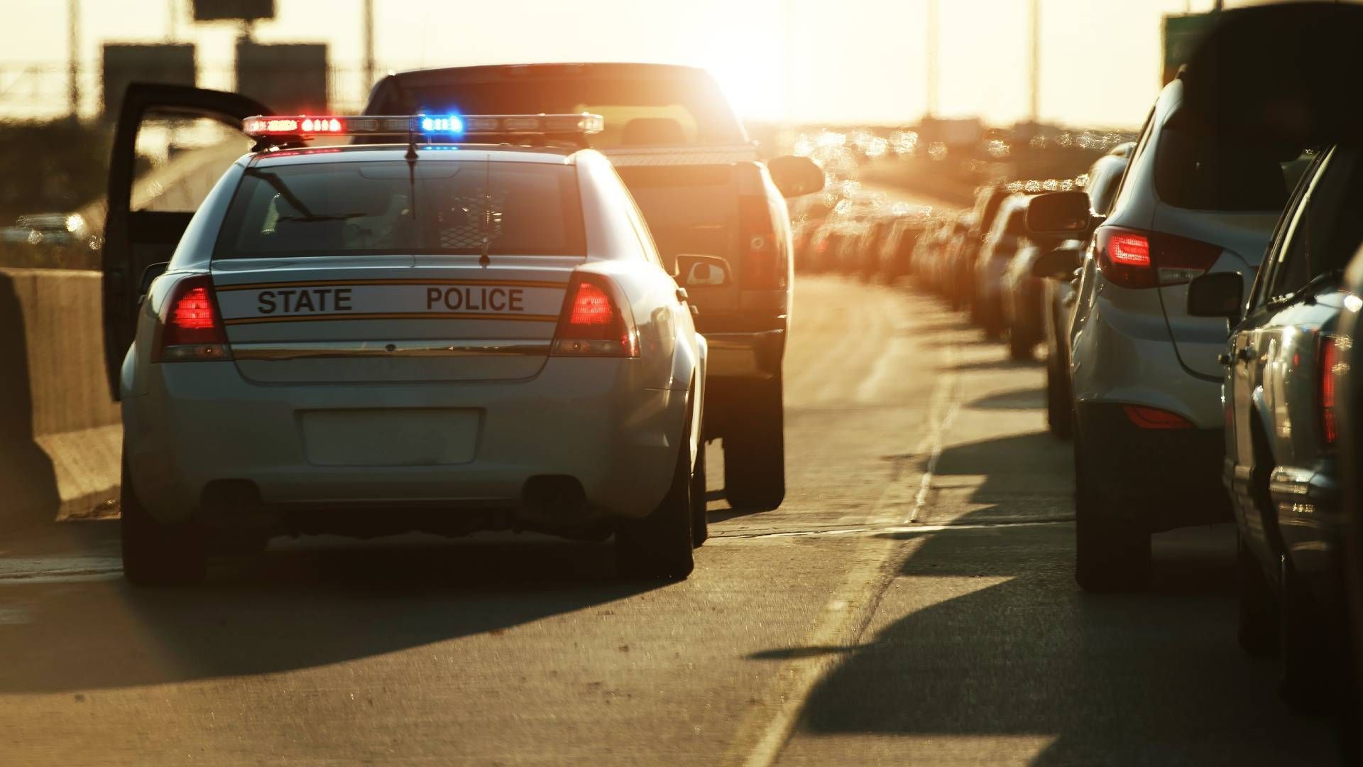 A police officer stopping a car by the highway near Lexington, Kentucky (KY)