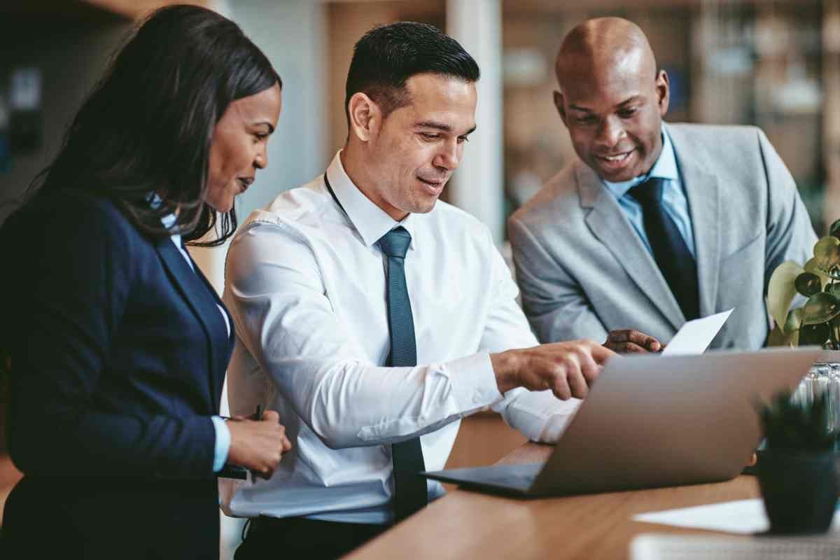 Three lawyers gathered around a laptop near Lexington, Kentucky (KY)