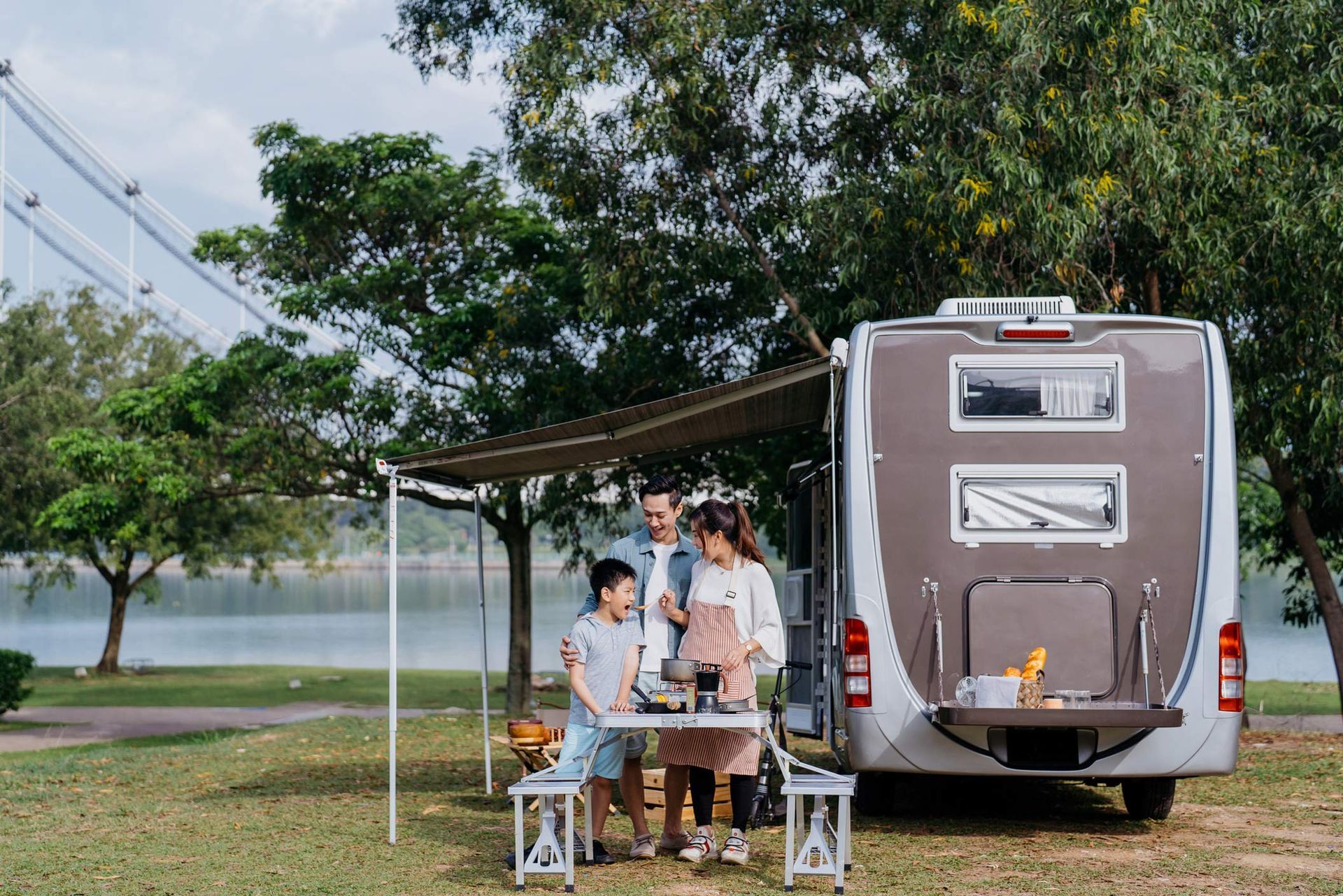 Family caravan picnic vacation at public park.