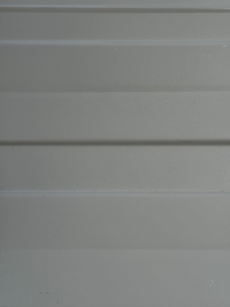 A close up of a white wall with a striped pattern.