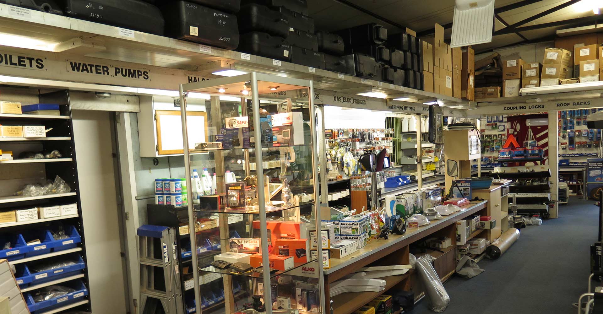 A warehouse filled with lots of shelves and boxes including toilets and water pumps