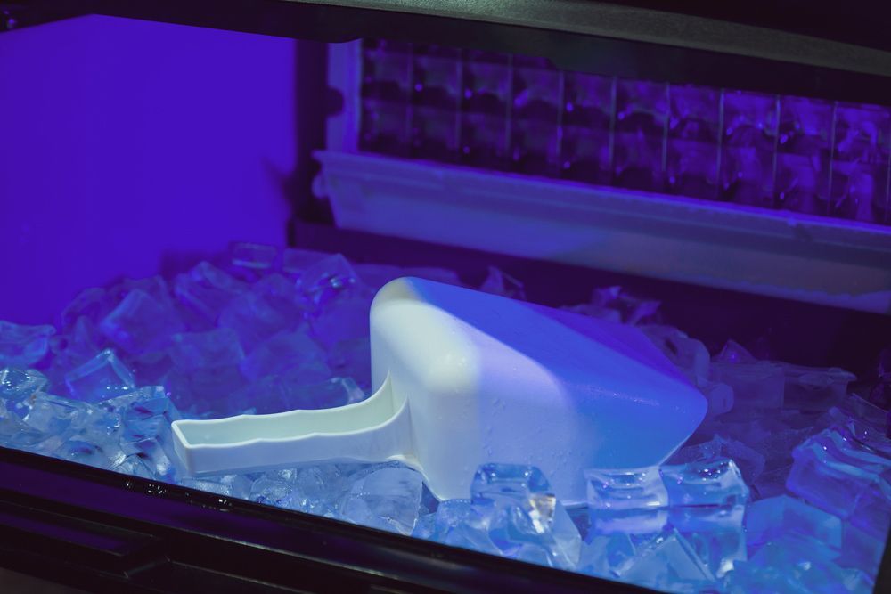 A Scoop Is Sitting on Top of Ice Cubes in An Ice Maker - Townsville Ice Machine in Mount Isa, QLD