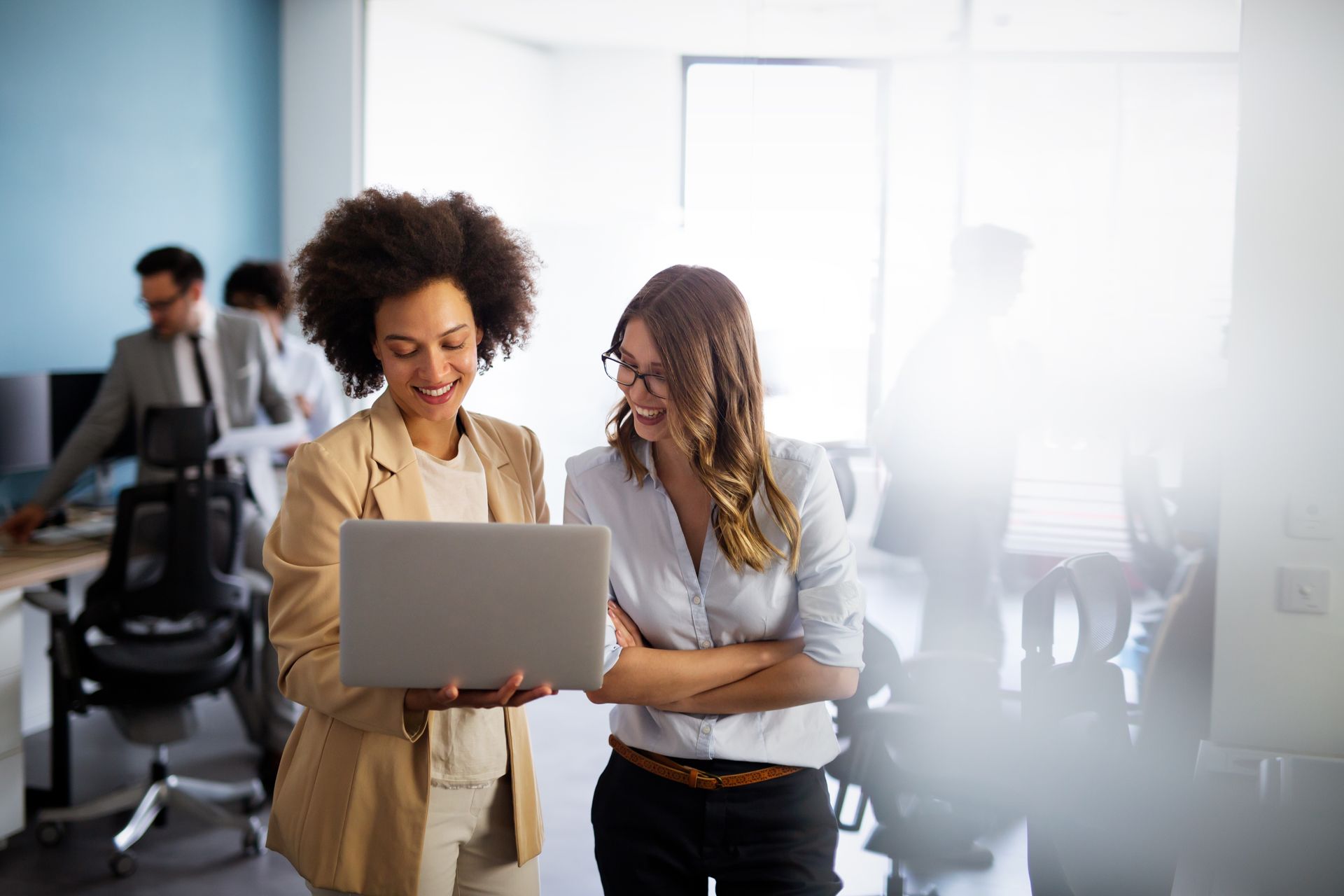 Two women are looking at a laptop