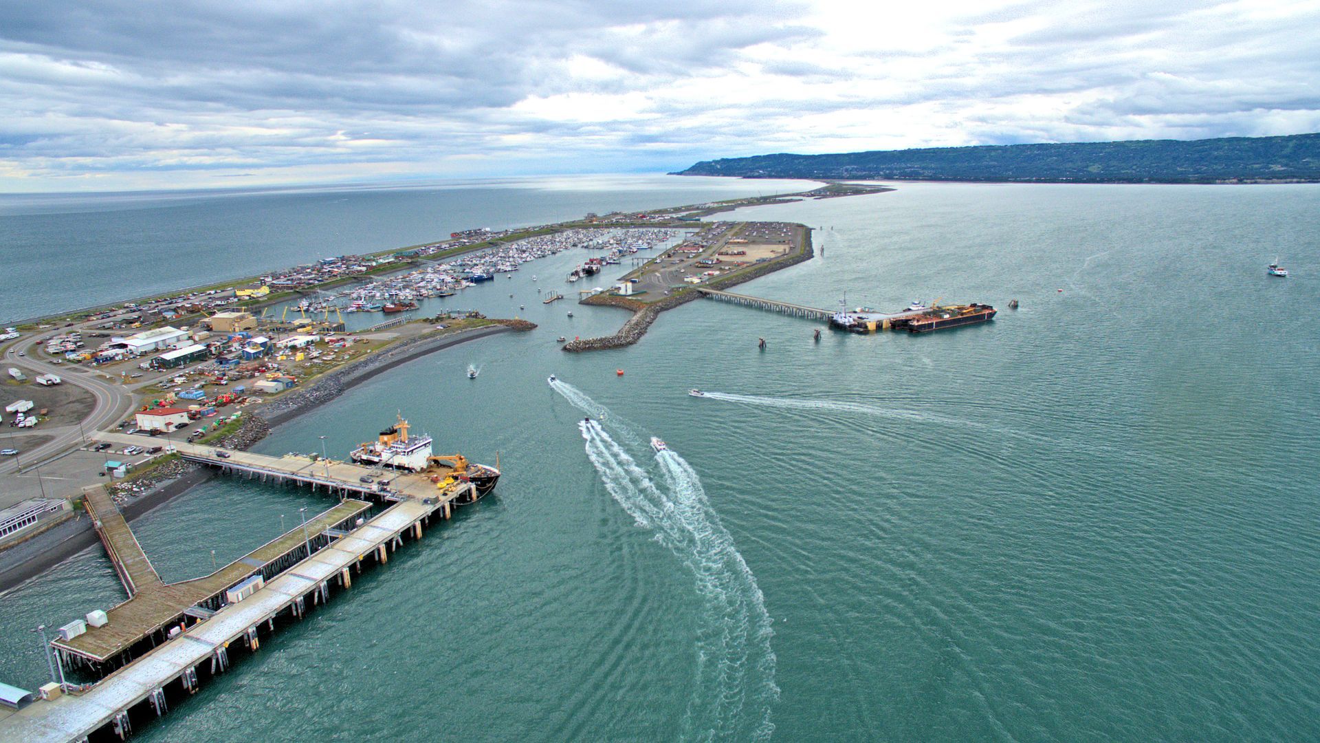 An aerial view of a pier in the middle of a body of water.