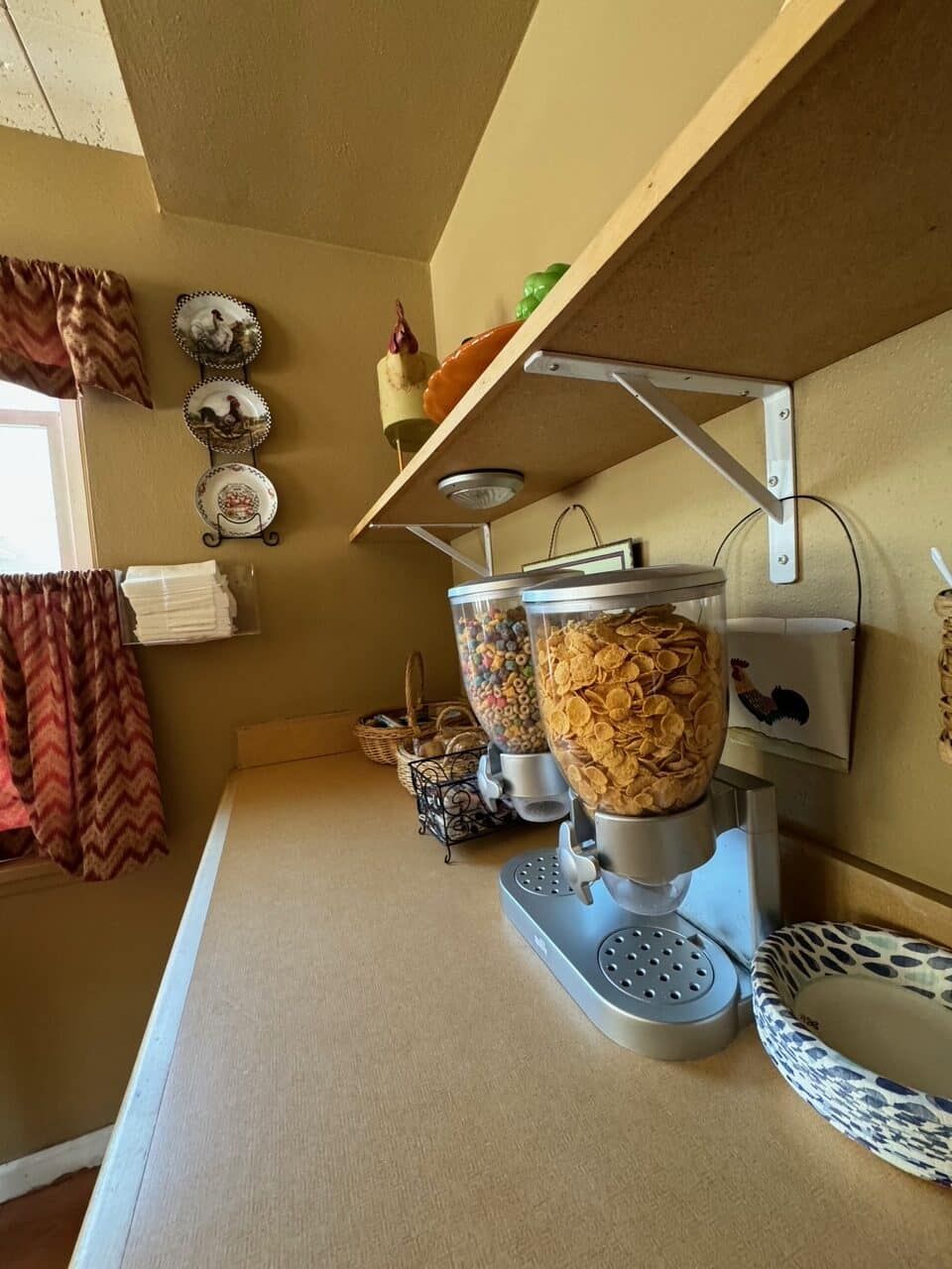A cereal dispenser sits on a counter in a kitchen