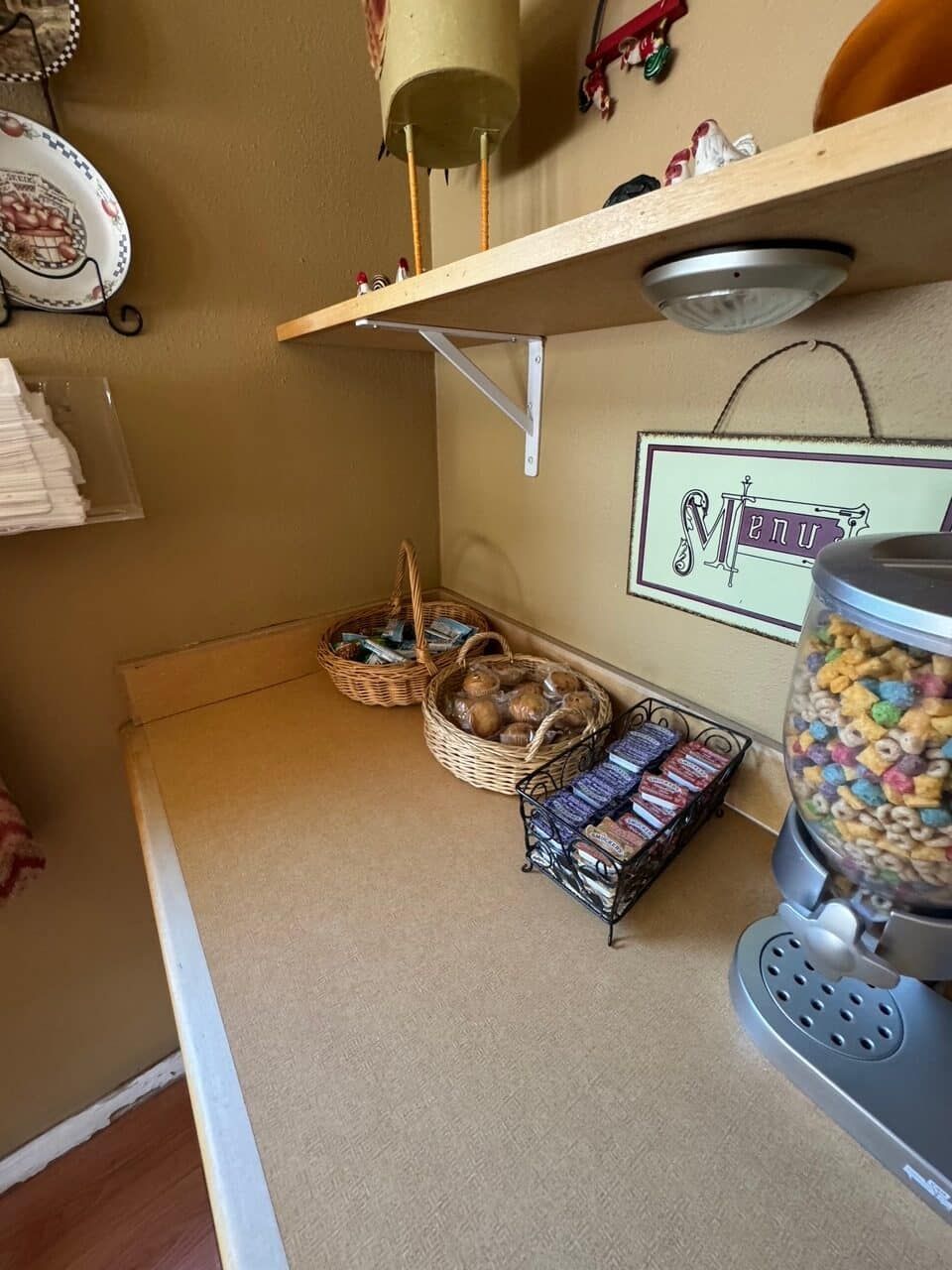 A cereal dispenser sits on a counter in a kitchen