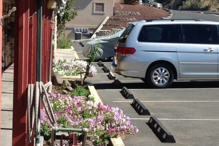 A silver minivan is parked in a parking lot