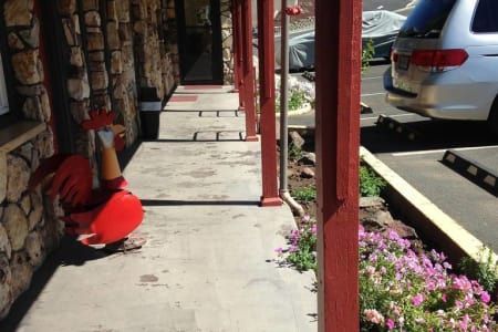 A white van is parked in a parking lot next to a stone building