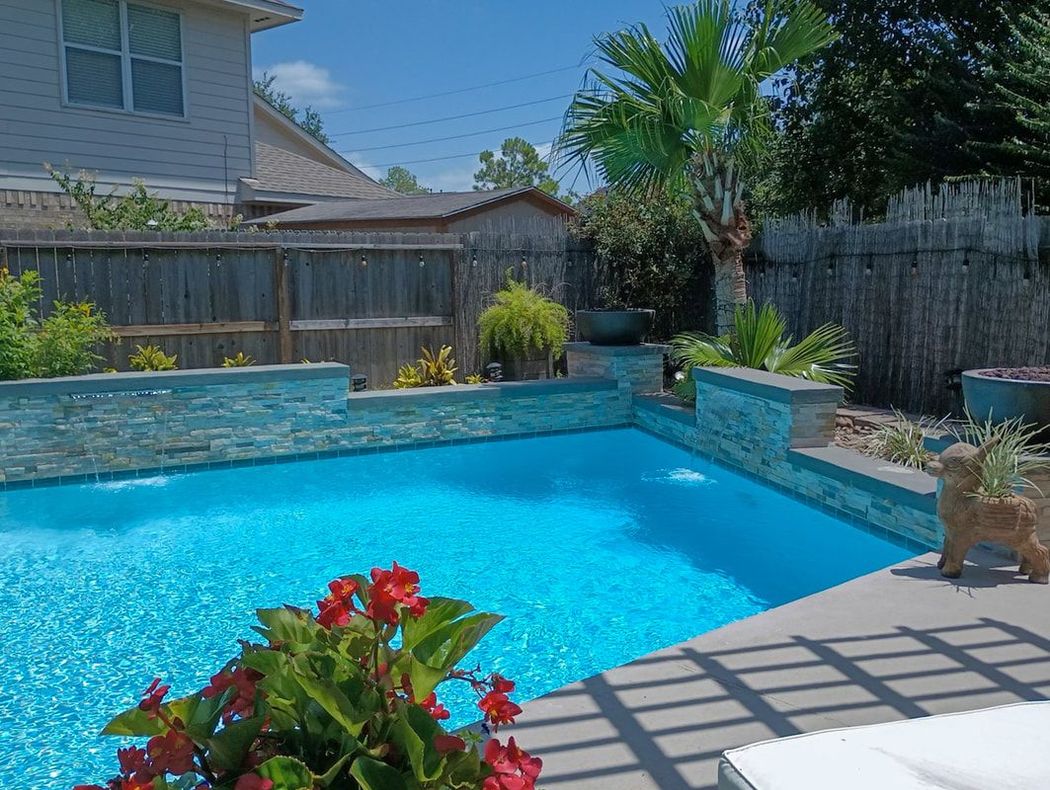 A large swimming pool in the backyard of a house