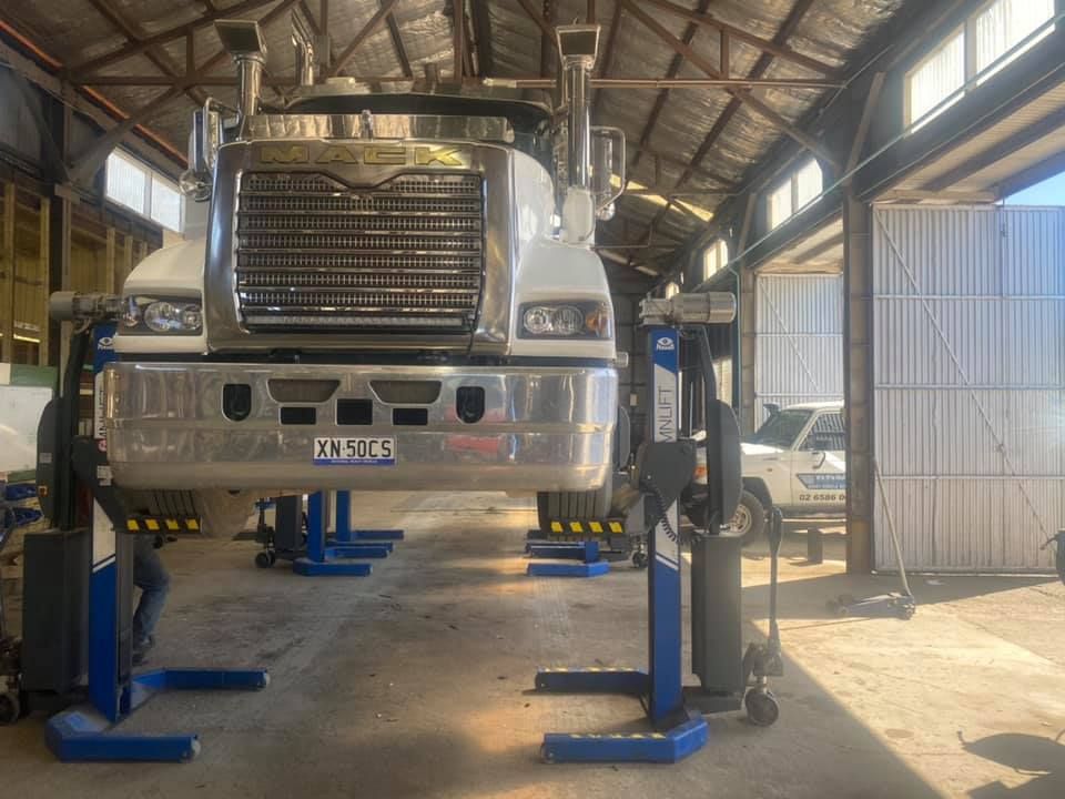 A truck is sitting on a lift in a garage. — BDM Heavy Vehicle Repairs In Wauchope, NSW