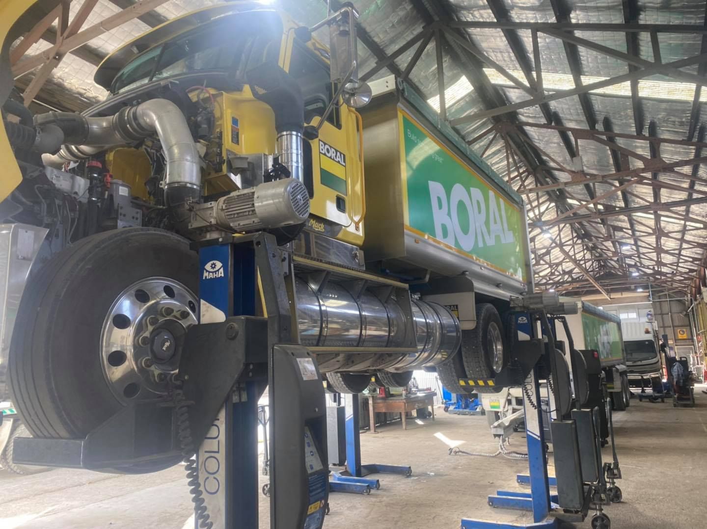 A truck is sitting on a lift in a garage. — BDM Heavy Vehicle Repairs In Wauchope, NSW