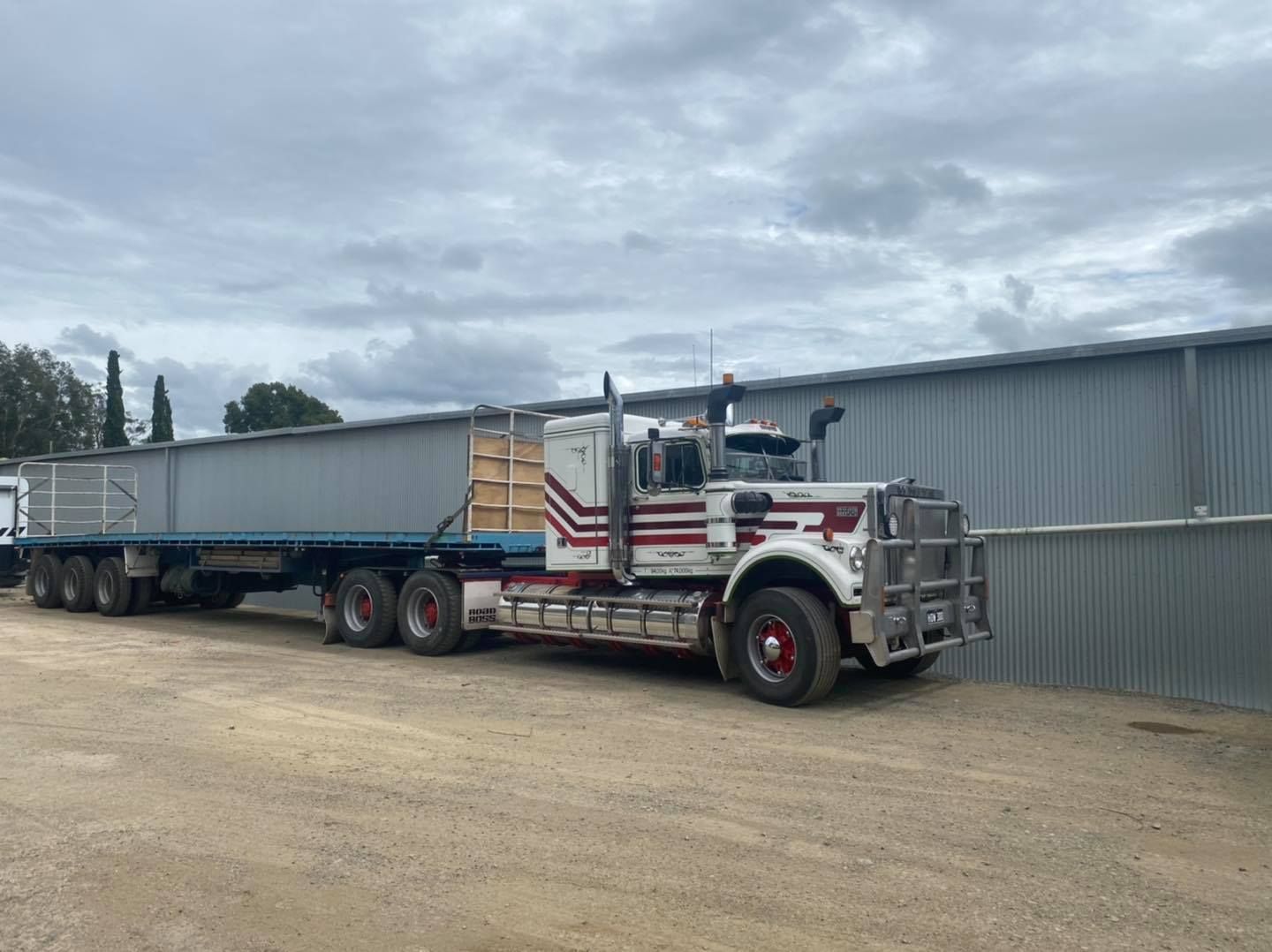 A Semi Truck is Parked in a Dirt Lot Next to a Building — BDM Heavy Vehicle Repairs In Port Macquarie, NSW