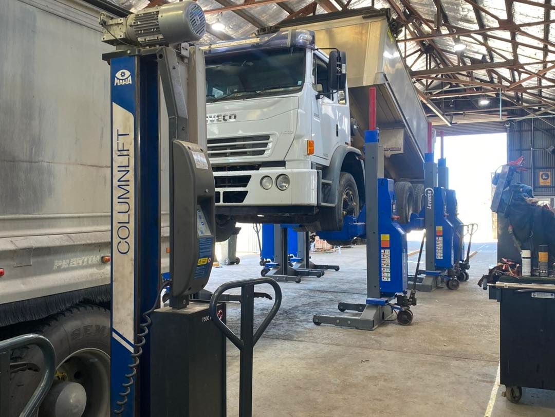 A Truck is Sitting on Top of a Lift in a Garage — BDM Heavy Vehicle Repairs In Wauchope, NSW