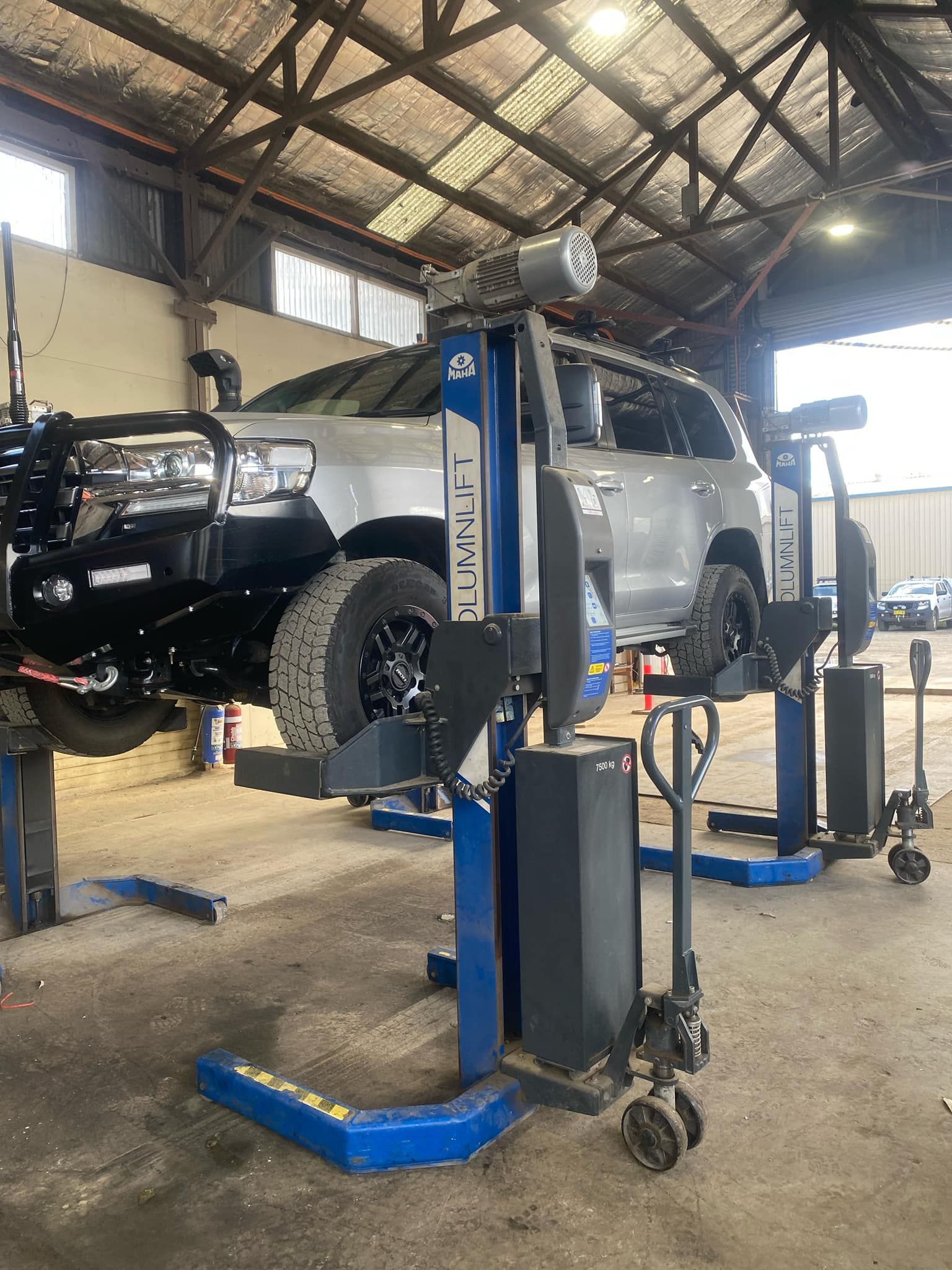 A truck is sitting on a lift in a garage.— BDM Heavy Vehicle Repairs In Port Macquarie, NSW