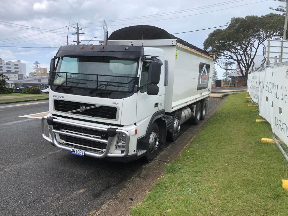 A White Dump Truck is Parked on the Side of the Road — BDM Heavy Vehicle Repairs In Taree, NSW