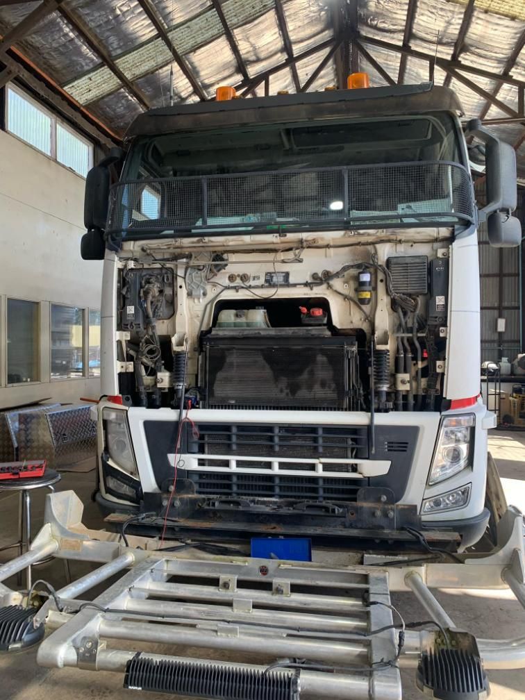 A Truck With Its Hood Open is Sitting on a Lift in a Garage — BDM Heavy Vehicle Repairs In Kempsey, NSW