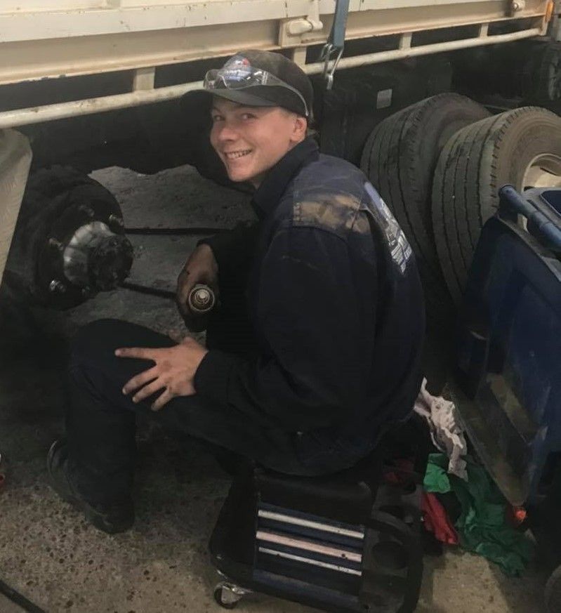 A Man Wearing a Hat and Goggles is Working on a Truck — BDM Heavy Vehicle Repairs In Wauchope, NSW