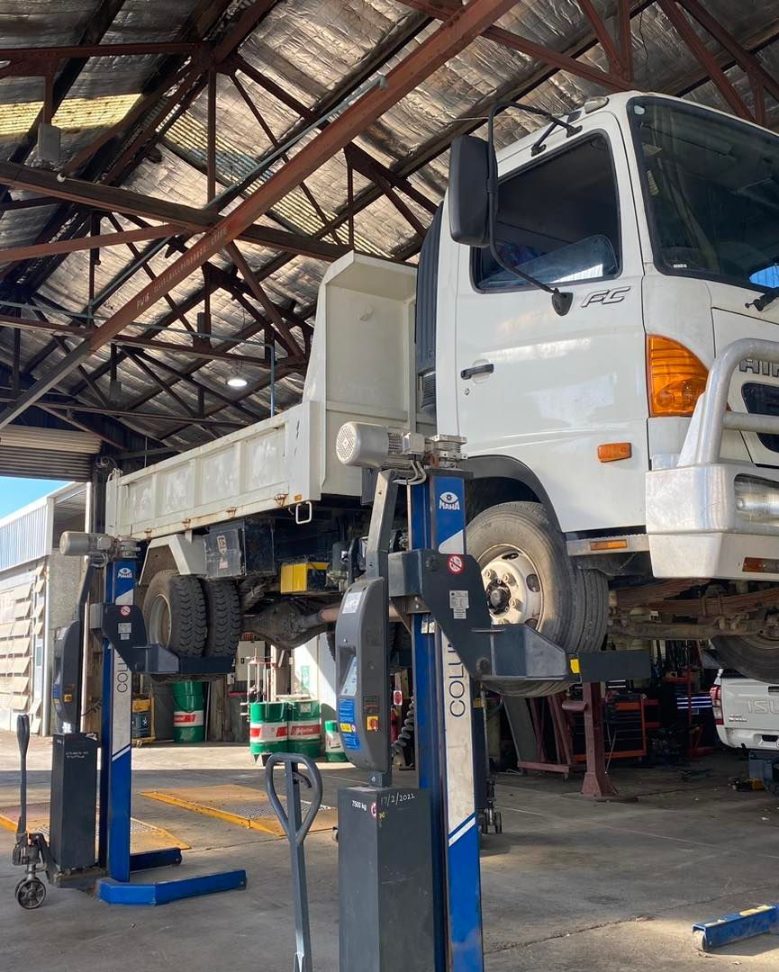 A White Truck is Sitting on a Lift in a Garage — BDM Heavy Vehicle Repairs In Wauchope, NSW