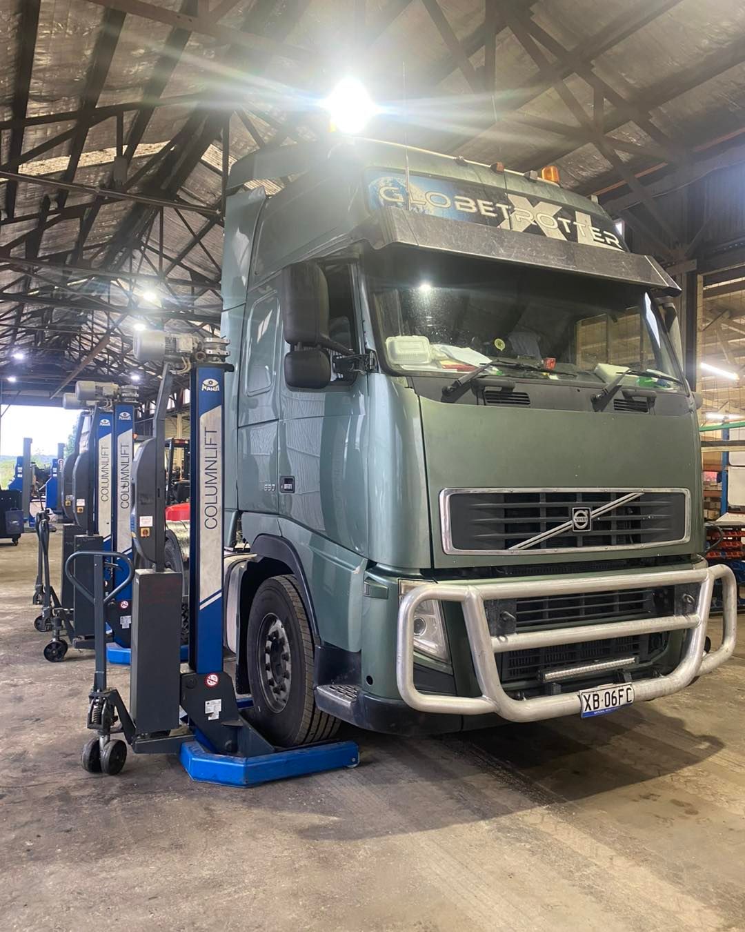 A volvo truck is parked on a lift in a garage.— BDM Heavy Vehicle Repairs In Wauchope, NSW