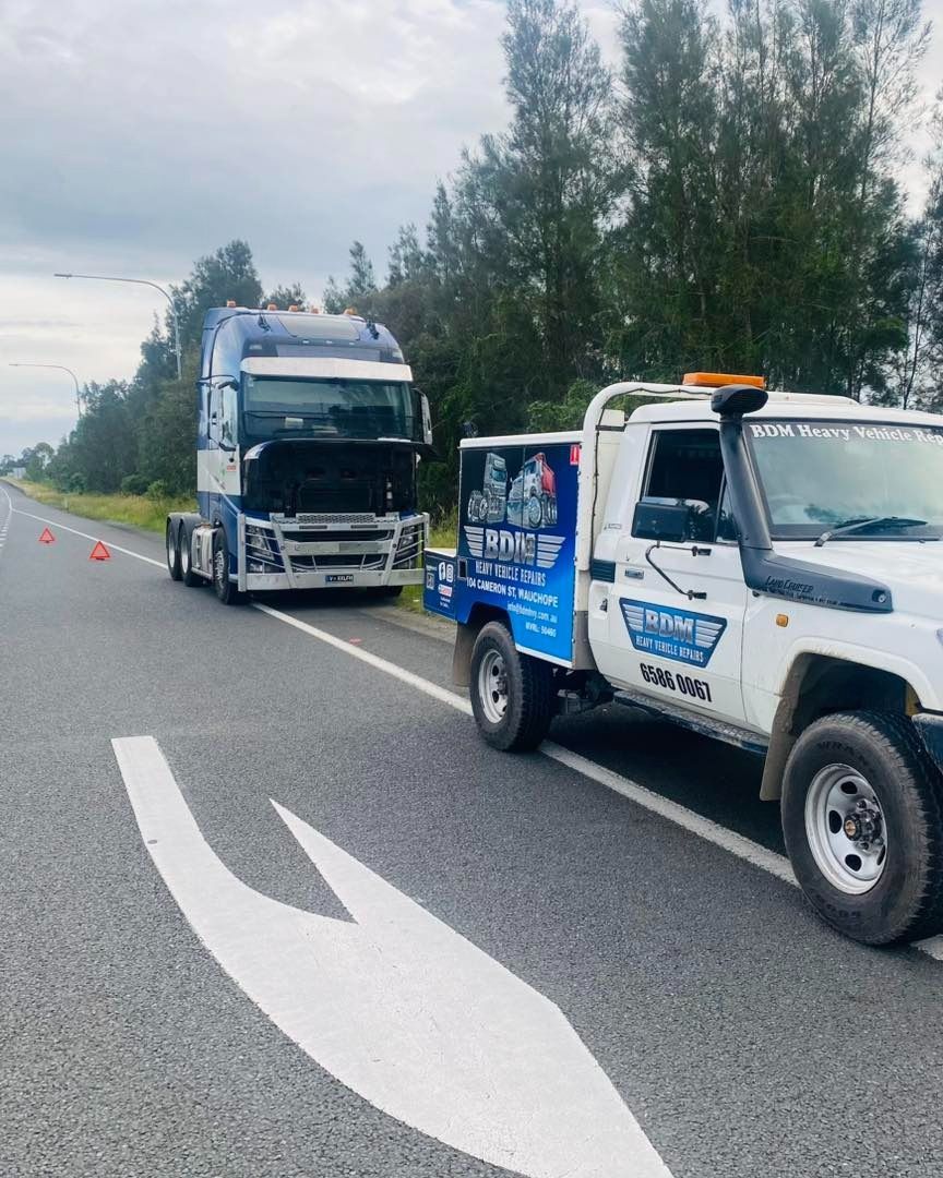 Tow Truck and a Parked Semi-truck