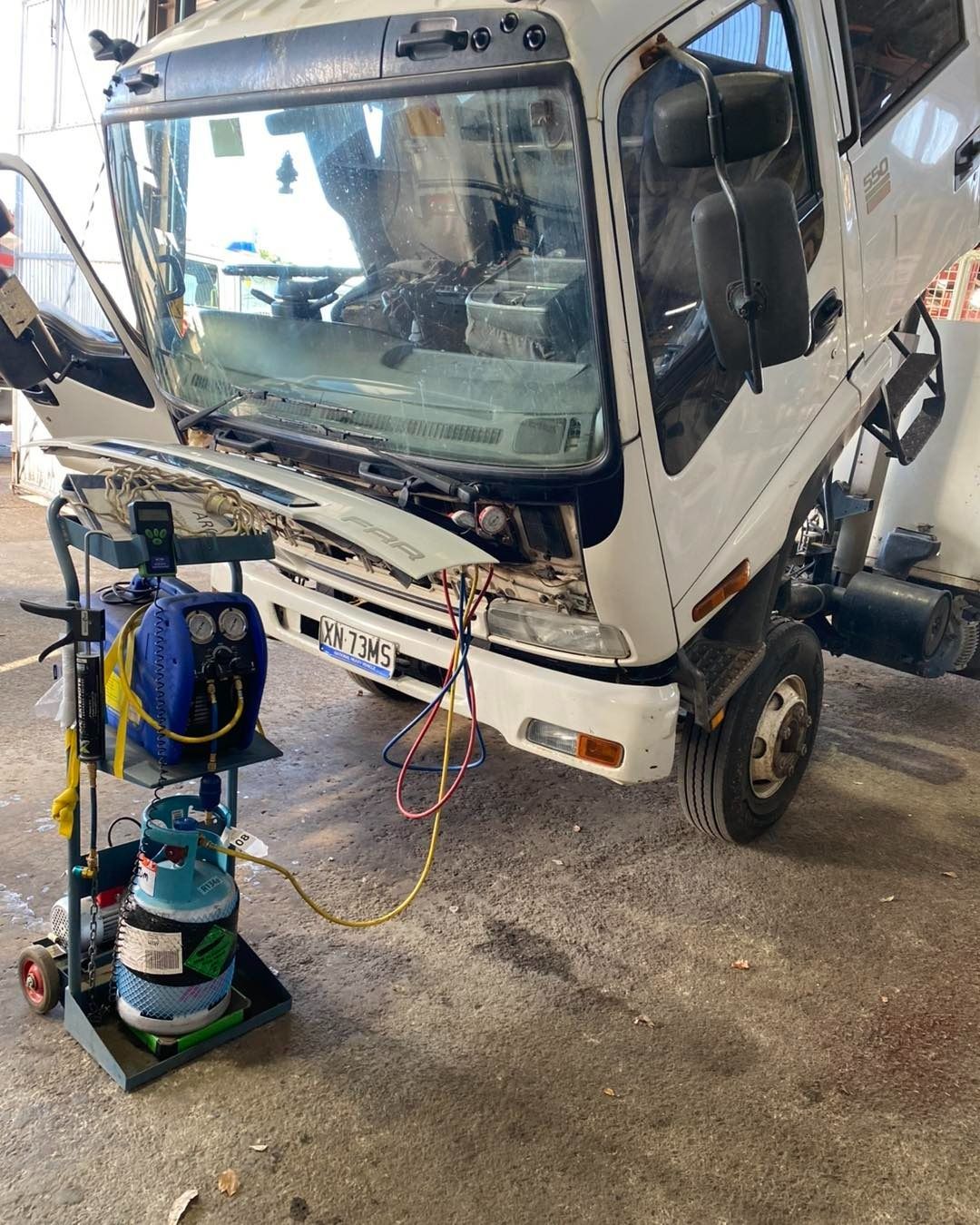 White Truck Being Serviced in a Garage
