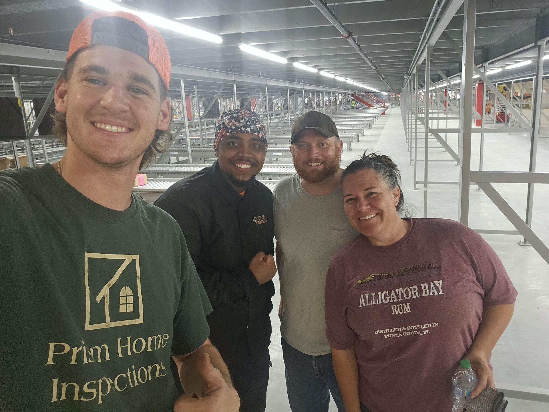 A group of people are posing for a picture and one of them is wearing a shirt that says prim home inspections