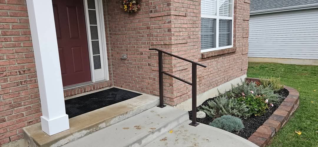 A brick house with a ramp leading to the front door.