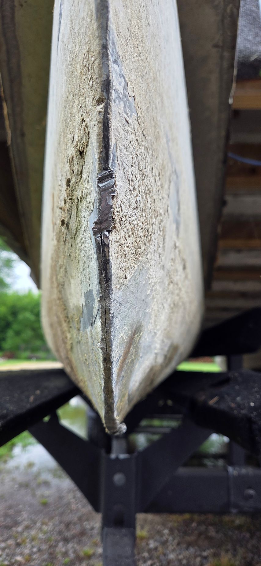 A close up of the bottom of a boat on a trailer.