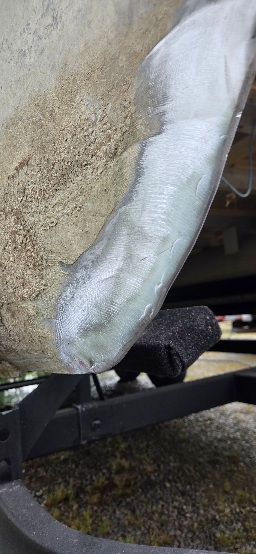 A close up of a metal fender on a car.