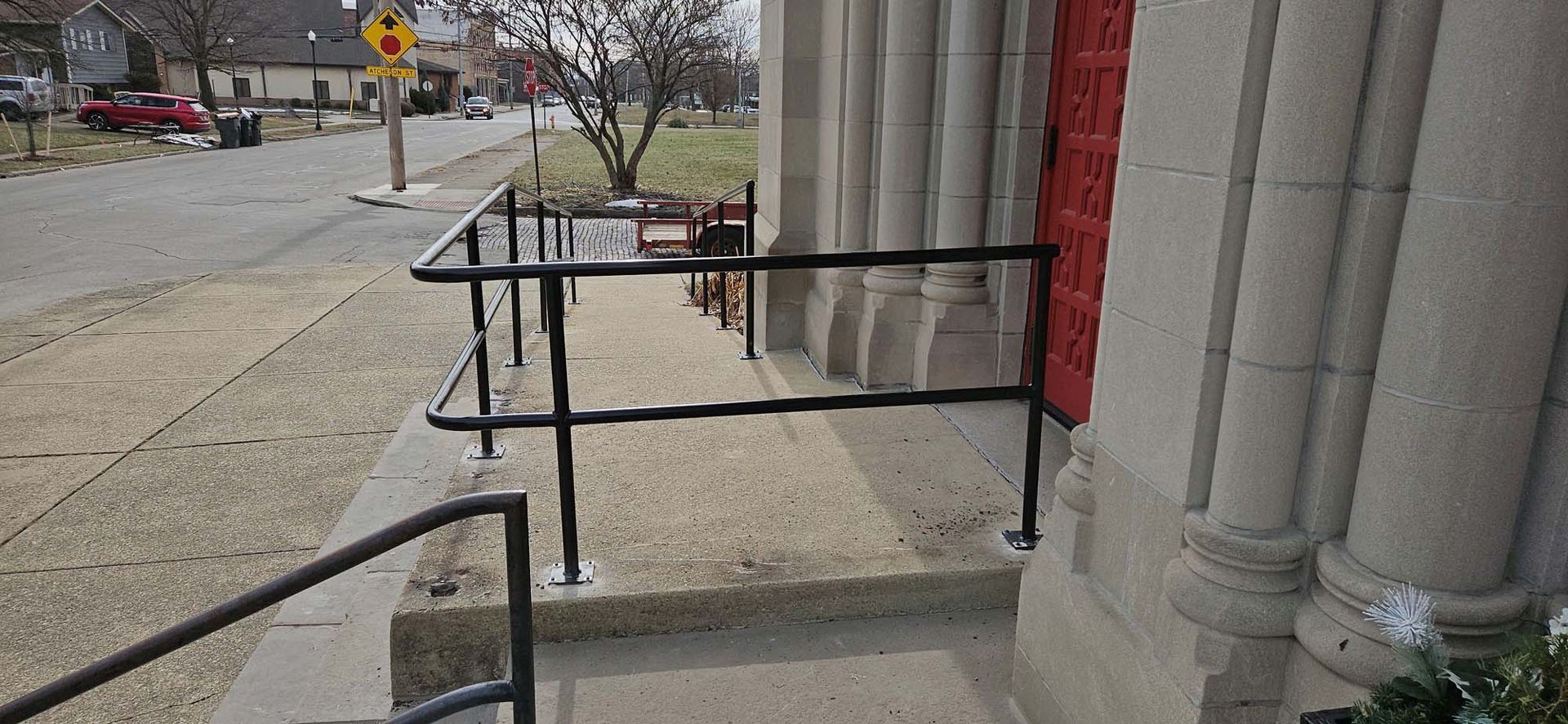 A staircase leading up to a building with a railing.