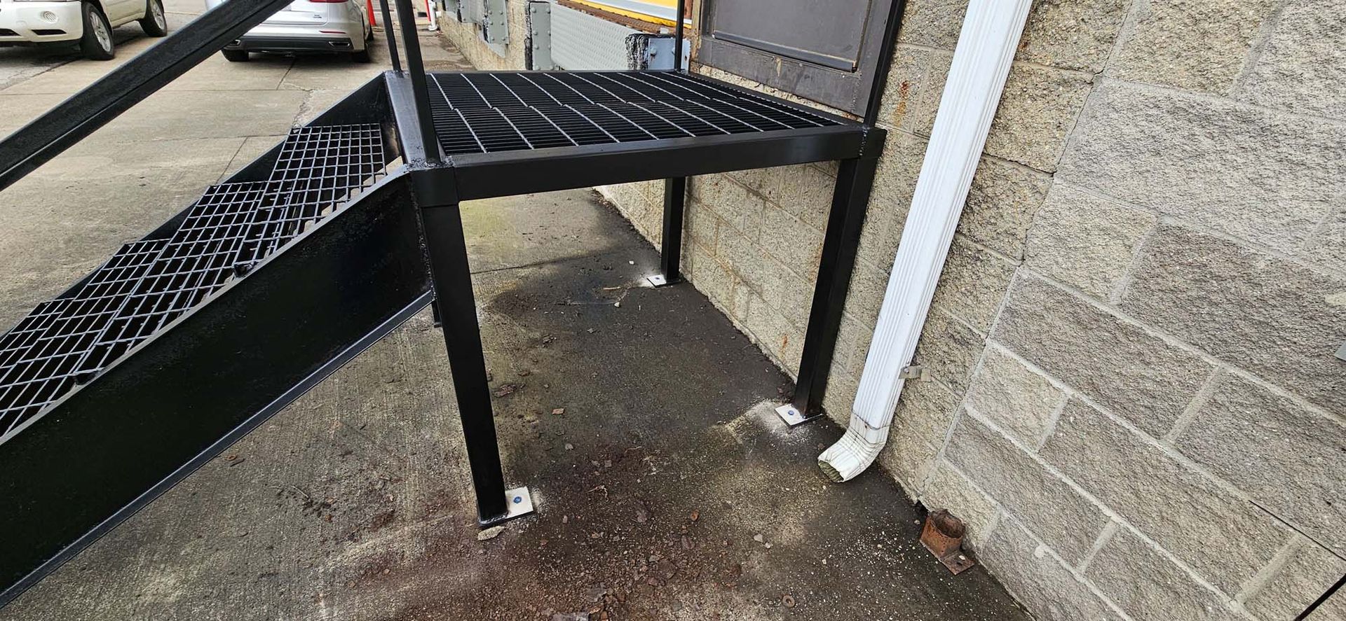 A metal ramp is attached to the side of a building.