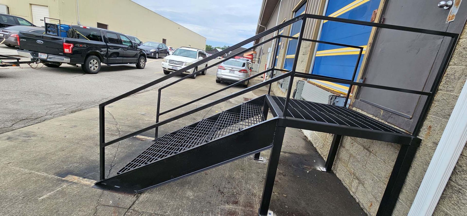 A set of stairs leading up to a building with a railing.