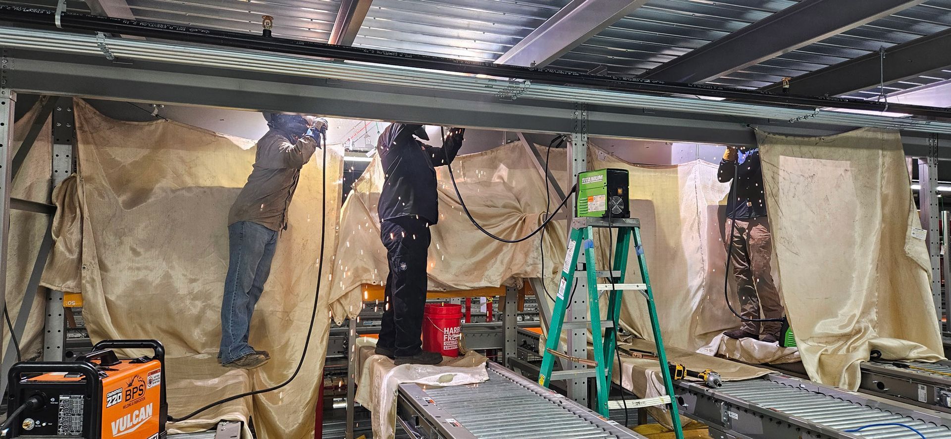 A group of men are working on a conveyor belt in a factory.