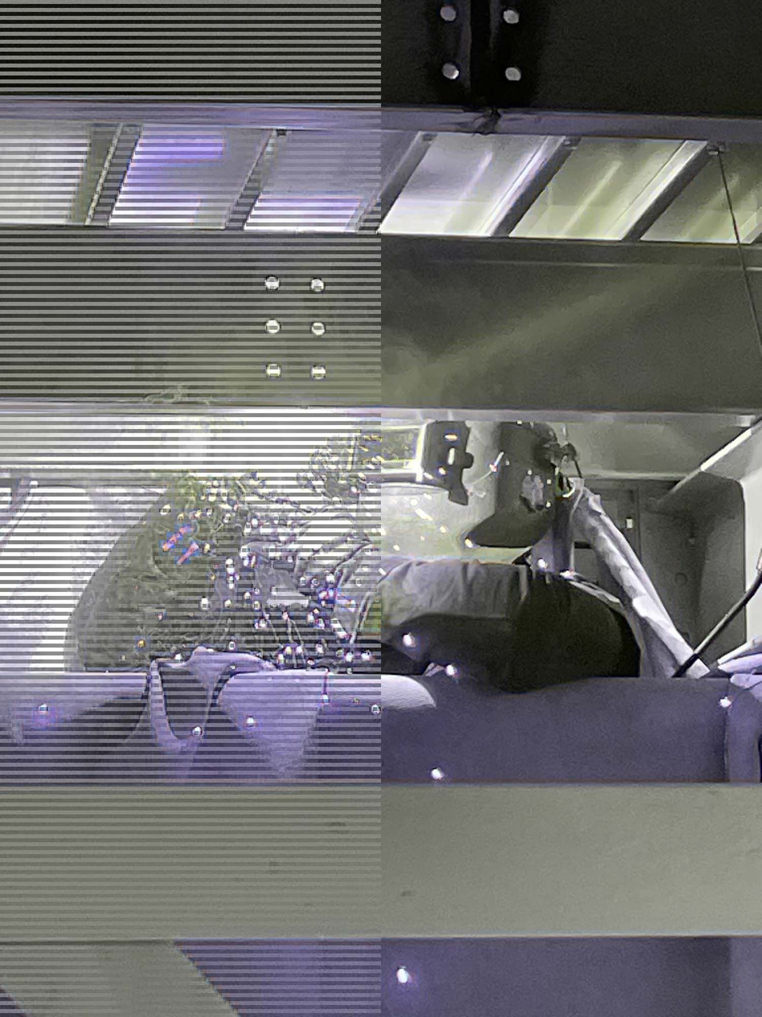 A black and white photo of a person standing in front of a window.